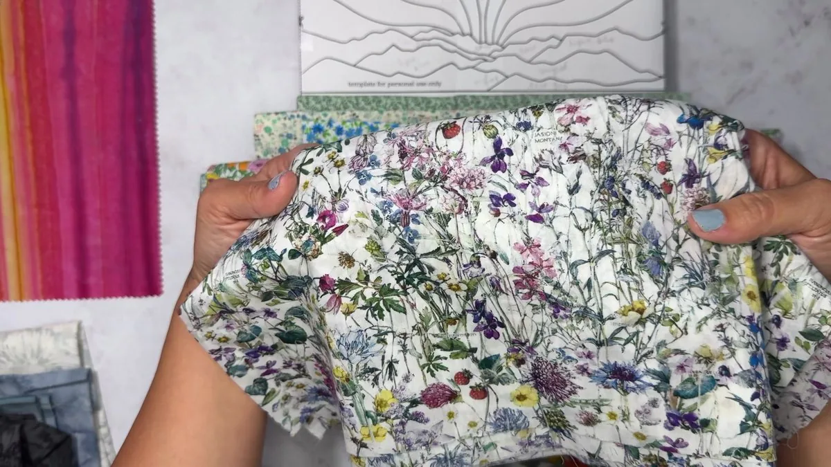 Module 3: Hannah holding floral fabric over the template while planning the meadow